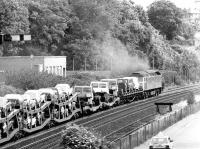 Heading east out of Dundee towards Broughty Ferry in August 1981, a class 47 starts to accelerate away with a freight consisting of miscellaneous new cars, vans and trucks.<br><br>[John Furnevel 11/08/1981]