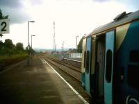 The 12.04 to Aberystwyth awaits departure time at Newtown on 21 July under the watchful eye of the RETB mast.<br><br>[Ken Strachan 21/07/2011]