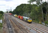 Feightliner 66556 heads east along the Great Western main line towards London on 11 August 2011 after being held for nearly 90 mins on the western approach to Didcot station [See image 35224]<br><br>[Peter Todd 11/08/2011]