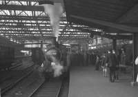 J21 0-6-0 no 65033 stands at Carlisle platform 4 on 7 May 1960 with the R.C.T.S. (N.E. Branch)/Stockton & Darlington Locomotive Society J21 Rail Tour. According to the station clock, the special is already 5 minutes down on its scheduled 4.30pm departure time for the return trip to Darlington via Penrith, Appleby East and the Stainmore route.<br><br>[K A Gray 07/05/1960]