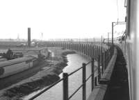 The northern approach arches of the 1868 Runcorn Viaduct carrying the railway across the Mersey between Runcorn and Widnes. Photographed from the LCGB (North West Branch) <i>Two Cities Limited Rail Tour</i> on 23 June 1968. The special, hauled by Stanier 8F 2-8-0 no 48033, has just crossed the river and is starting to turn west towards Liverpool Lime Street with the last leg of the tour from Manchester Victoria. <br><br>[K A Gray 23/06/1968]