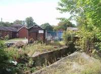 The view into the old railway yard at Whittingham Hospital from the site of the passenger station, the limit of normal passenger services. Although closed in 1957 the bridge that stood in the foreground was only recently removed. Beyond is the old weighbridge house and through the blue fence the former engine shed can be seen. Wagonloads of coal continued beyond the yard through the hospital grounds to the boilerhouse. <br><br>[Mark Bartlett 01/09/2011]