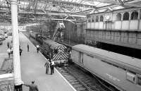 The Haymarket steam crane in attendance at Waverley station in 1975 to rescue errant diesel shunter no 08564. One of the old mechanical signal boxes looks over the scene from the station's south wall.<br><br>[Bill Roberton //1975]