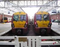 Busy scene at Helensburgh Central on 3 September, with platform 3 accommodating 320307, platform 2 is occupied by 334024 on the 1210 service to Edinburgh Waverley, while 334027 is about to depart from platform 1 with the 1140 hrs also to Edinburgh Waverley.<br><br>[John McIntyre 03/09/2011]