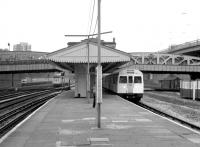 View west at Royal Oak station half a mile out of Paddington on the Metropolitan Hammersmith and City Line in 1982, with a service for Barking at the platform. Over on the left a Brush Type 4 is approaching on the main line with a Bristol - Paddington train, while a local DMU stopping service from Reading is held at signals in the centre of the picture.<br><br>[John Furnevel 22/01/1982]