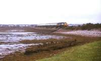 A train for the far north approaching Clachnaharry shortly after leaving Inverness in July 1991.<br><br>[Ian Dinmore /07/1991]