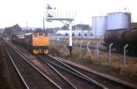 In October 1972 the daily freight to Inverness waits for the incoming mid-day down passenger train to clear the Bonar Bridge (now Ardgay) to Lairg section before continuing south. Lairg oil depot stands in the background.<br><br>[David Spaven /10/1972]