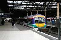 A Glasgow shuttle stands at the west end of Waverley in December 2004 sporting the livery applied by the previous franchise holder, National Express Group. FirstGroup had taken over ScotRail operations in October that year.<br><br>[John Furnevel 03/12/2004]