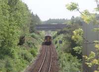 The view east towards Castle Kennedy from the small overbridge near Stranraer Town as 156449 heads for the port. The building on the right was formerly part of the rail freight handling facilities at this location. [See image 34207] for the view west from the same bridge.<br><br>[Mark Bartlett 23/05/2011]