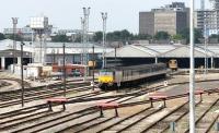 Part of the carriage sidings at Old Oak Common, seen on a quiet mid-week afternoon in July 2005. The locomotive with empty stock in the centre of the picture is FGW <I>Sleeper</I> liveried class 57 no 57605 <I>Totnes Castle</I>. Long lens view south west from the wall running alongside the Grand Union Canal.  <br><br>[John Furnevel /07/2005]