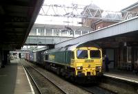 Freightliner 66537 heads north past the little known Nuneaton Tower, overlooking platform 1. It's not as tall as Blackpool Tower, but a lot closer to the trains.<br><br>[Ken Strachan 09/09/2011]