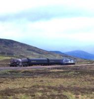 A Transrail-liveried Class 37 breasts Corrour Summit with a short freight heading for Fort William in 1998. [See image 26495] [With thanks to Hamish Ballie, Vic Smith, Ian Mackie and Uilleim Jamieson]<br>
<br><br>[David Spaven //1988]