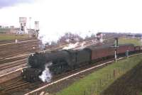 A V2-hauled goods from the ECML arrives at Millerhill South Junction on 21st April 1963, with the new Monktonhall Colliery prominent in the background and the Waverley Route running diagonally through the centre of the picture.<br><br>[Frank Spaven Collection (Courtesy David Spaven) 21/04/1963]