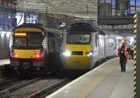 East Coast power car 43308 waits to leave Edinburgh Waverley in a westerly direction with the 11.34 to Kings Cross via Carlisle (because of engineering work at Abbeyhill Junction) on 24 September 2011. 170434 has just arrived alongside with a service from Fife.<br>
<br><br>[Bill Roberton 24/09/2011]