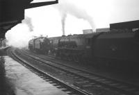 Pacifics in the rain. View south from below the platform 4 canopy at Carlisle during a downpour on 28 December 1963. The photograph shows relief locomotives 46237 <I>City of Bristol</I> (left) awaiting the arrival of the up <I>Royal Scot</I>, with sister locomotive 46240 <I>City of Coventry</I>, waiting to take forward the following Edinburgh - Birmingham New Street.<br>
<br><br>[Robin Barbour Collection (Courtesy Bruce McCartney) 28/12/1963]