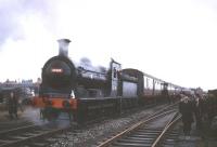 J36 0-6-0 65345 with a special at a point approximately 250 yards east of the former Fauldhouse and Crofthead station (closed 1930). The train is <I>Scottish Rambler no 5</I> and the date is 11 April 1966. The J36 had brought the special along this surviving section of the line from Polkemmet Junction, retained to serve Levenseat quarry and works (the junction for which can be seen on the right) although it was closed to all traffic beyond Whitburn later that year. For a more recent view [see image 35803] <br><br>[Robin Barbour Collection (Courtesy Bruce McCartney) 11/04/1966]