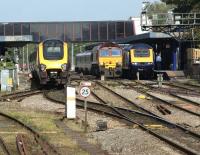 Busy period at Oxford on 22 September 2011. On the left is an Arriva Cross Country service heading for Manchester and on the right the driver of a First Great Western HST looks back along his train which will shortly depart for Paddington. In the middle is DBS 66001 waiting to follow in the path of the HST towards Didcot.<br><br>[John McIntyre 22/09/2011]