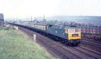 The 10.10 Edinburgh - Kings Cross passes the disused roundhouse at Tweedmouth on Saturday 20 June 1970 with Brush Type 4 no 1501 accelerating after the Berwick stop. Just visible alongside the yard offices above the second coach is the yellow cab end of what is thought to be Blackstone 0-6-0 DE shunter (class 10) No. D3638, which was occupied at that time in lifting the Kelso branch [see image 30192].<br><br>[Bill Jamieson 20/06/1970]