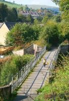 A young lady and her dog stroll across the bridge over the Gala Water on the morning of 28 September 2011, having just passed the site of Kilnknowe Junction at the northern end of the bridge. This is the first of many bridges to be crossed by trains leaving Galashiels for Edinburgh when the line reopens in 2014. Photographed from the road overbridge carrying Plumtreehall Brae.<br><br>[John Furnevel 28/09/2011]