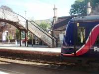 The Up platform station building and footbridge at Pitlochry are seen here in June 2011 with the town centre buildings behind. 170433 draws to a halt on a ScotRail Inverness to Glasgow service.<br><br>[Mark Bartlett 28/06/2011]