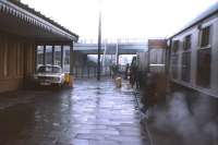 When Muir of Ord station re-opened in 1976, having been closed for 16 years, it had a station building, a parcels service and steam heating, as shown in this early 1977 shot. Nowadays it has a bus shelter of course! [See image 5856]<br><br>[Frank Spaven Collection (Courtesy David Spaven) //1977]