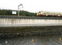 The 12.27 Milngavie - Edinburgh Waverley about to pass the 'Holmes Summit' board alongside Hillend reservoir, between Caldercruix and Blackridge, on 19 September 2011 [see image 35721].  <br><br>[John Furnevel 19/09/2011]