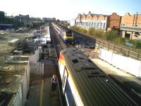 So much for the goods yard [see image 30501]; but the platforms are being doubled in length - a rare example of trickle-down to the regions from the 2012 Olympics, as Loughborough University will be the official preparation centre for <I>'Team GB'</I> athletes. All 3 platforms are at work here, with a 222 in platform 1, an HST arriving from the North into 2, and a 158 disappearing under the distant bridge from 3. Light engines tend to pass on the fourth track - to the right in this view.<br><br>[Ken Strachan 30/09/2011]