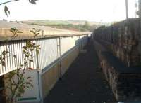 The small terminus at Bacup was quickly demolished after closure on 5 December 1966 and replaced with a factory building. 45 years later this is the view along the trackbed from the buffers with only the retaining wall remaining to identify the location. [See image 33963].<br><br>[Mark Bartlett 29/09/2011]