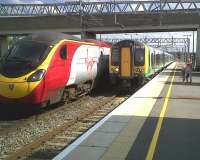 <h4><a href='/locations/M/Milton_Keynes_Central'>Milton Keynes Central</a></h4><p><small><a href='/companies/L/London_and_Birmingham_Railway'>London and Birmingham Railway</a></small></p><p>The Pendolino, the 350, and the three young ladies appear to be competing as to who can be most colourful. View South along platform 5 at Milton Keynes Central on 2 September 2011. 18/51</p><p>02/09/2011<br><small><a href='/contributors/Ken_Strachan'>Ken Strachan</a></small></p>