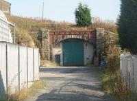 Since my last visit to the old Newline tunnel on the former Bacup to Rochdale line the workshop it contains seems to have closed and is awaiting new tenants. [See image 23305]. There is no significant cover over this short tunnel so perhaps the land was unstable leading to it being constructed rather than using a cutting.<br><br>[Mark Bartlett 29/09/2011]