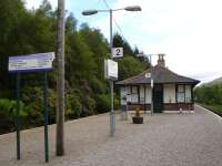 Tyndrum Upper station building north end and signage to greet travellers as seen from the stepped entrance in a quiet period between services. It must be some comfort to any non savvy walkers who have arrived near to time for a train to Oban to note that they need to then get to the lower station around 1.0Km away.<br><br>[David Pesterfield 20/06/2011]