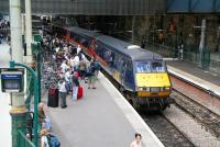 A late running morning GNER Glasgow Central - London Kings Cross service slowly draws to a halt at a crowded Edinburgh Waverley platform 2 on 5 July 2007.<br><br>[John Furnevel 05/07/2007]