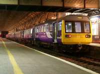 Half past midnight at Preston station on 15 October 2011 and 4 sets of DMUs are coupled together preparing for an ecs run to Blackpool carriage sidings. This particular mix has 142s at either end, with 150 and 156 units sandwiched in between. This was the second of three similar ecs movements over a period of 20 minutes.<br>
<br><br>[John McIntyre 15/10/2011]