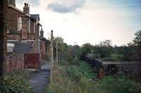 Some 11 years after the last train of sand trucks had left, Ditchingham station had become rather neglected and a washing line had been strung out along the platform by the inhabitants. In common with neighboring stations on the Waveney Valley line, the building did not survive beyond 1982 when the route of the A143 took over the trackbed.<br><br>[Mark Dufton 24/10/1976]