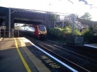 A northbound Voyager about to run non-stop through Wolverton station in October 2011. Notice the curvature of the track - the whole WCML was slewed around Wolverton works when it was built. Note also the rise in the platform level - unconventionally, the highest part is at the end!<br><br>[Ken Strachan 14/10/2011]