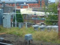 Grab shot from a westbound ATW train entering Wolverhampton High Level on 12 October showing some of the ongoing development work around the adjacent former low level station (closed to passengers 1972). The 30m mixed use scheme for the 9 acre Canal Quarter site proposed in 2005 envisaged a restored section of the former Grade II listed 1854 station as a centre piece using refurbished platforms as patio areas for various restaurants, cafes, pubs etc alongside new hotel and residential accomodation. [See image 19662]<br>
<br><br>[David Pesterfield 12/10/2011]