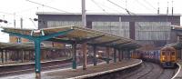 View over the south end of Carlisle station on a particularly wet Saturday afternoon on 3 September 2011. A Settle & Carlisle line service for Leeds prepares to leave platform 6, with trains for Newcastle and Manchester Airport standing at platforms 5 and 4 respectively.<br><br>[Andrew Wilson 03/09/2011]