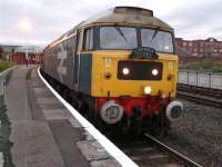 Eight o'clock on a Saturday morning at Kilmarnock station, with 47580 (plus 57601 on the rear) having recently arrived with a special to pick up passengers. The date is 22 October and the train is the outbound Compass Tours Ayr - York <I>'Settle & Carlisle Express'</I>.<br><br>[Ken Browne 22/10/2011]