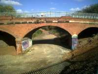 Not much has happened to this bridge since trains to Loughborough and Burton stopped running under it and Stoney Road was diverted away from its deck. But there are stirrings in the area - earthworks in the background mark the building of a site compound for the Nuneaton North Chord project. Unfortunately, the brief for this project includes the demolition of this bridge. View looks East on 22 October 2011, with the WCML about half a mile away.<br><br>[Ken Strachan 22/10/2011]