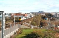 View west from Edinburgh Park towards the city centre on 27 October 2011. On the right the tramworks continue their inexorable progress west between the road and the railway, while on the left is the unusual sight, at this time of the afternoon at least (13.10), of the Kings Cross bound <I>Highland Chieftain</I> slowing for the Haymarket stop. The train was some 2 hours down on its schedule as a result of <I>poor rail conditions</I> (sic) south of Inverness [see news item].  <br><br>[John Furnevel 26/10/2011]