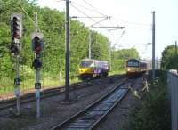 The north end of Wakefield Westgate station on 2 June 2011. On the left 144005 stands in the down side layover siding, from which it will eventually move back into platform 2 to form the 08.39 service to Leeds via Huddersfield, Halifax & Bradford. On the right 321903 will arrive imminently at platform 1 and leave as the 08.32 all stations to Doncaster. Just visible by the lower left cab corner of 144005 is milepost 176 (from Kings Cross).<br><br>[David Pesterfield 02/06/2011]