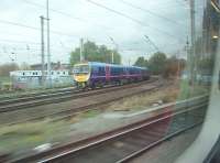 Bearing left to take the Blackpool line at Fylde Junction on 27 October is TPE 185115, as seen from a northbound Pendolino taking the line to Lancaster. To the right is St Walburgh's church, a prominent feature in many steam age photographs.            <br><br>[Mark Bartlett 27/10/2011]