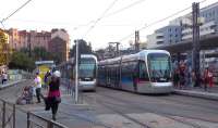 Trams at the rail and bus station transport hub in Grenoble on 27 September 2011. These are both examples of the latest (2008) additions to the TAG fleet, low-floor Alstom Citadis vehicles. A fifth tram line is due to be completed by 2014. Other extensions and further lines are proposed.<br><br>[Andrew Wilson 27/09/2011]