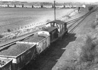 Clayton 8607 pulls away from Smeaton sidings in the summer of 1971 with a loaded coal train from Dalkeith Colliery for Millerhill Yard. The village of Whitecraig stands to the north in the background.  <br><br>[John Furnevel 28/07/1971]