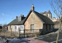 Entrance to the westbound platform from the south side of Shotts station in February 2006, complete with surviving station building. View across the running lines to the higher level entrance to the eastbound platform from Station Road, top right.<br><br>[John Furnevel 13/02/2006]