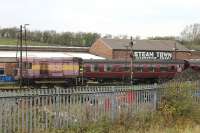 Still TOPS registered but confined to the West Coast yard at Carnforth is shunter 08418. Its EWS red and gold livery is perhaps better described as pink and yellow but it is kept busy moving stock and locomotives around the complex. Its a long time since the old shed was known as <I>Steamtown</I>.<br><br>[Mark Bartlett 24/10/2011]