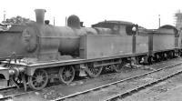 Robinson C14 4-4-2T no 67448 photographed on Mexborough shed in the 1950s. The shed's new coaling plant is under construction in the right background. Mexborough shed was officially closed by BR in 1964, at which time it carried the code 41F.<br><br>[K A Gray //]