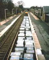 A class 37-hauled freight special conveying flagstone paving from Georgemas Junction to Kyle of Lochalsh drifts through the platforms of Tain station in 1997. [See image 38387]<br><br>[David Spaven Collection //1997]