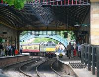 D7628 has drawn up with a train of empty stock at the north end of platform 1 at Pickering station on 28 June 2011. View under the new overall roof completed earlier in the year.<br><br>[John Furnevel 28/06/2011]