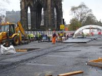 Frost protection covering being put in place over freshly laid and floated concrete on Princes Street between Waverley Bridge and the Scott Monument on 8 November 2011. A cast catenary support mast mounting base can be seen centre left by the white bulk bag. A number of the easily portable half moon 'tents' are in use along the works site.<br><br>[David Pesterfield 08/11/2011]